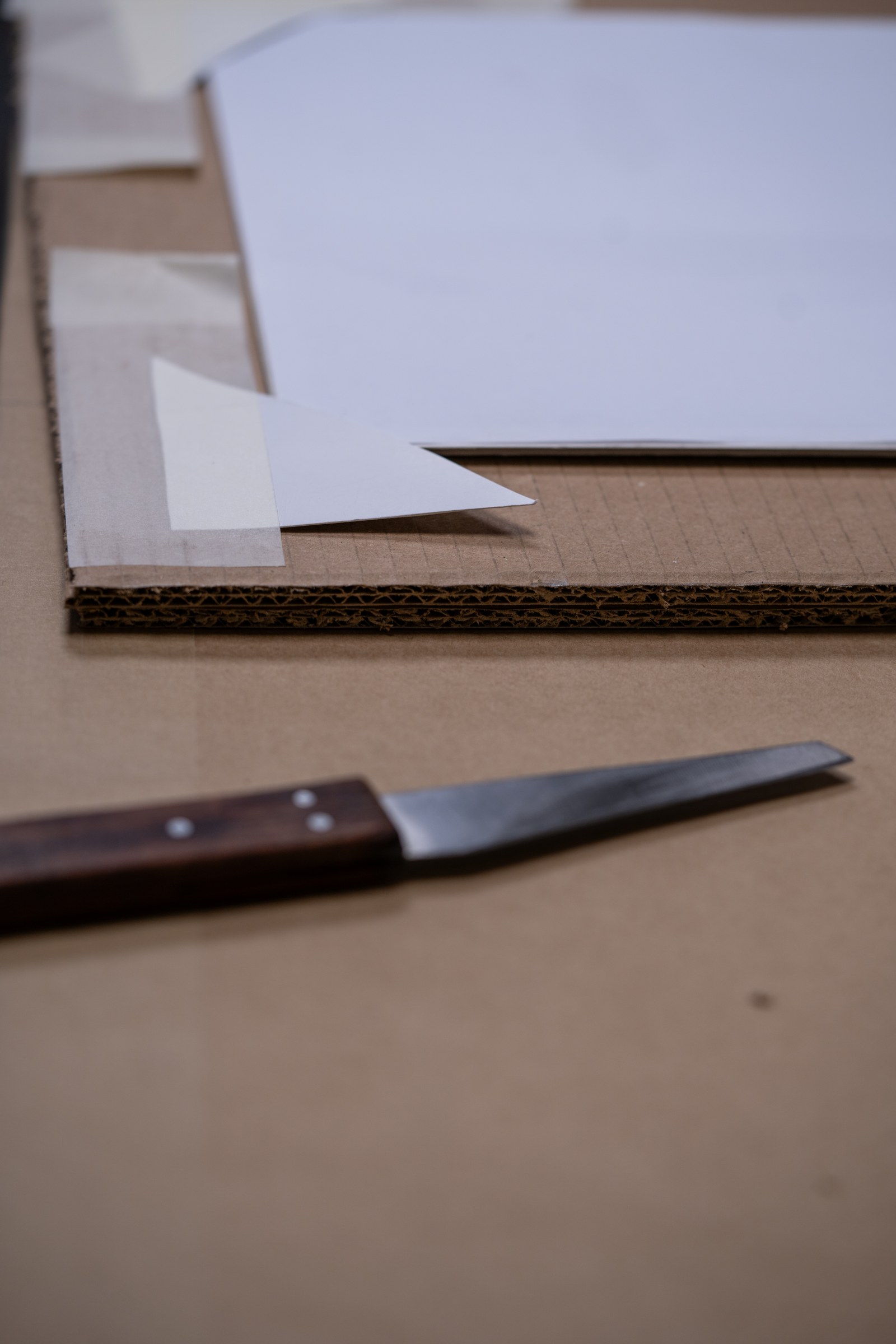 Fine art packing materials being cut and prepared on a workbench.